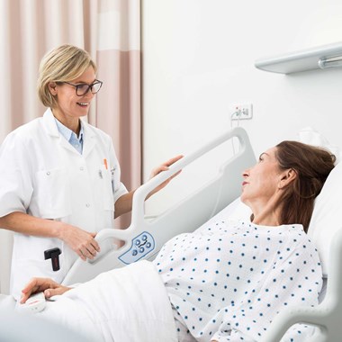 Caregiver and patient with nurse call in hospital